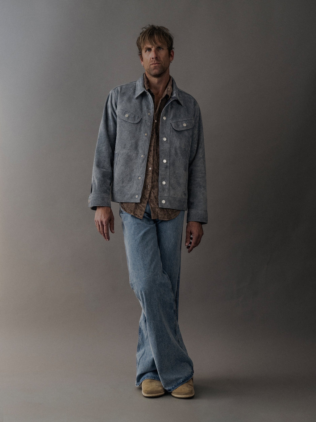 David Dangelo Caldwell light blue suede trucker jacket with exposed seams, reversible design, and proprietary hardware.