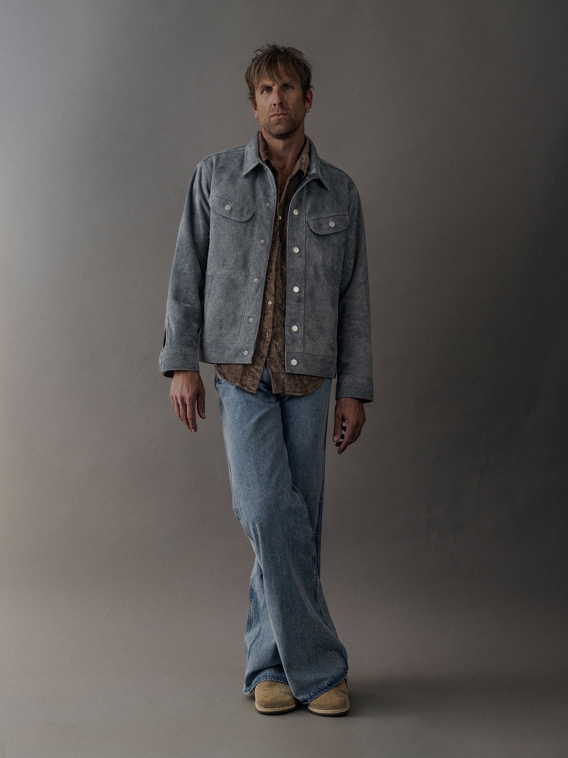 David Dangelo Caldwell light blue suede trucker jacket with exposed seams, reversible design, and proprietary hardware.