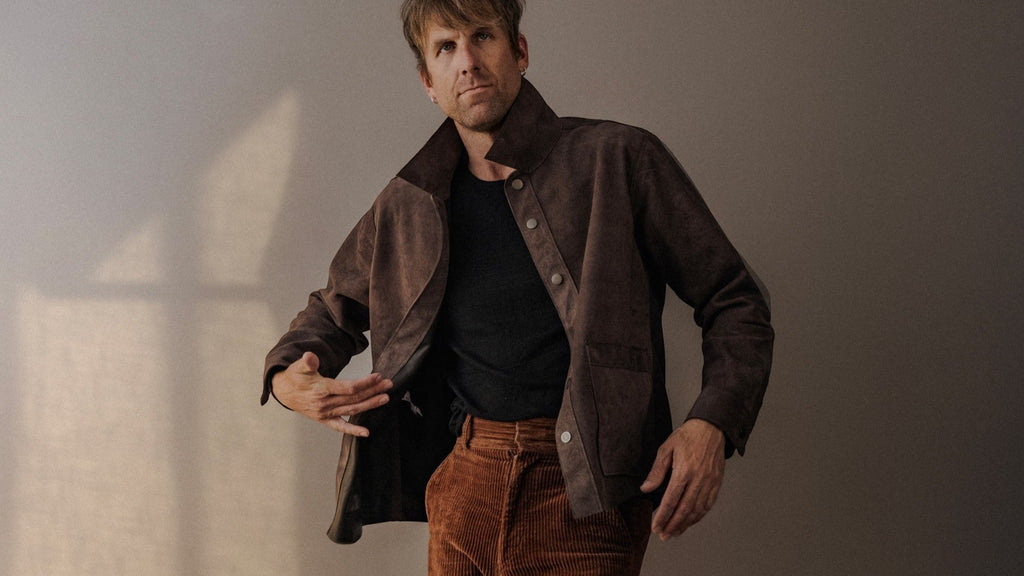 David Dangelo Caldwell brown suede jacket with exposed seams and patch pockets. Classic fit, made in USA.