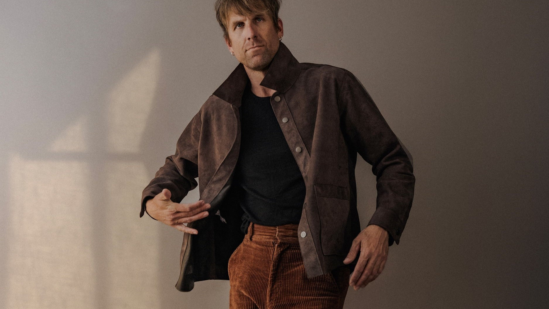 David Dangelo Caldwell brown suede jacket with exposed seams and patch pockets. Classic fit, made in USA.