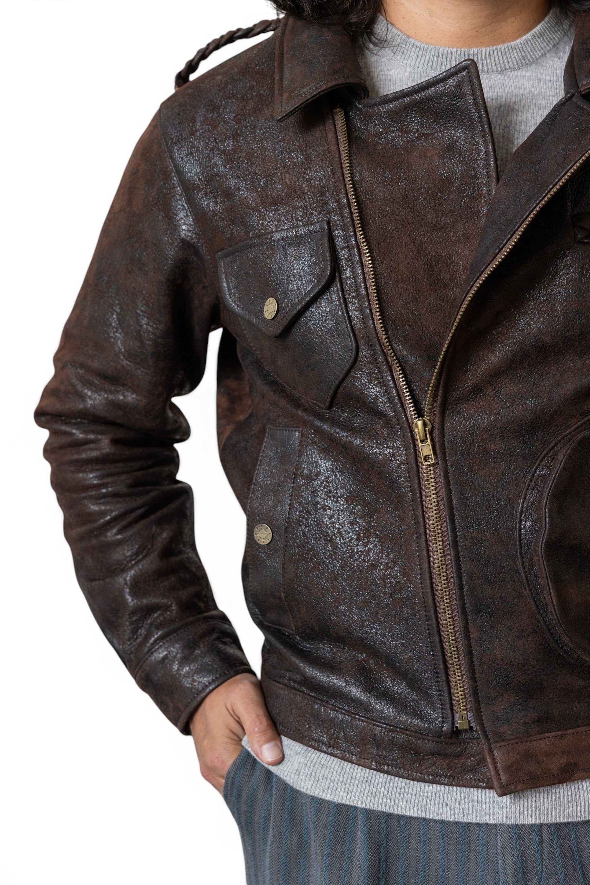 David Dangelo Caldwell chocolate brown textured Italian lamb leather jacket with multiple pockets and braided shoulder detail.