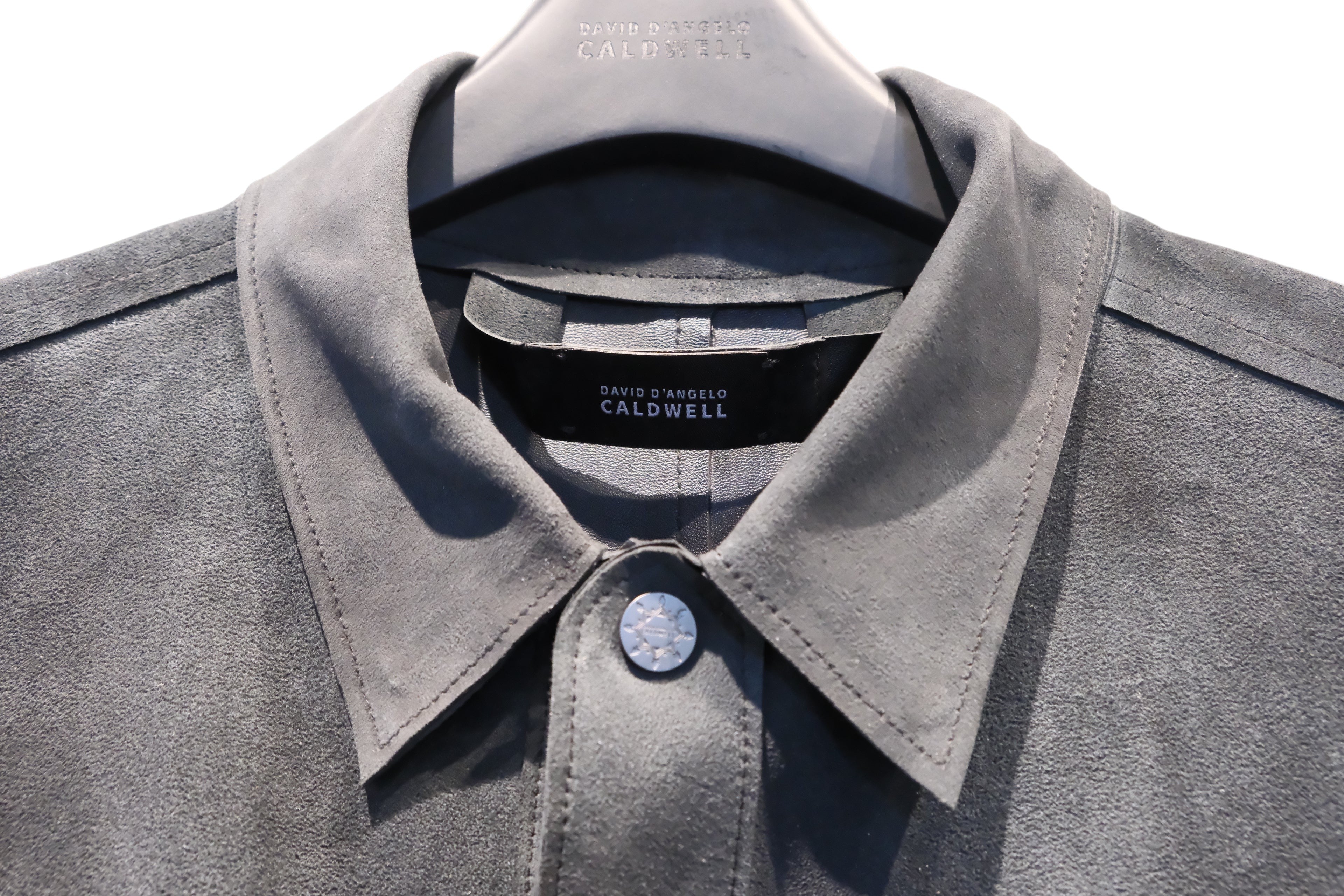 David Dangelo Caldwell grey suede jacket with exposed seams and custom hardware button.