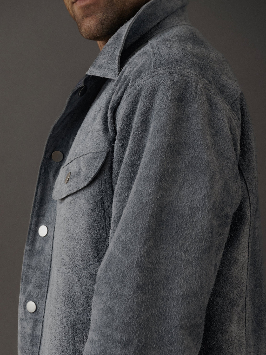 David Dangelo Caldwell grey suede trucker jacket with exposed seams and proprietary hardware. Reversible design.