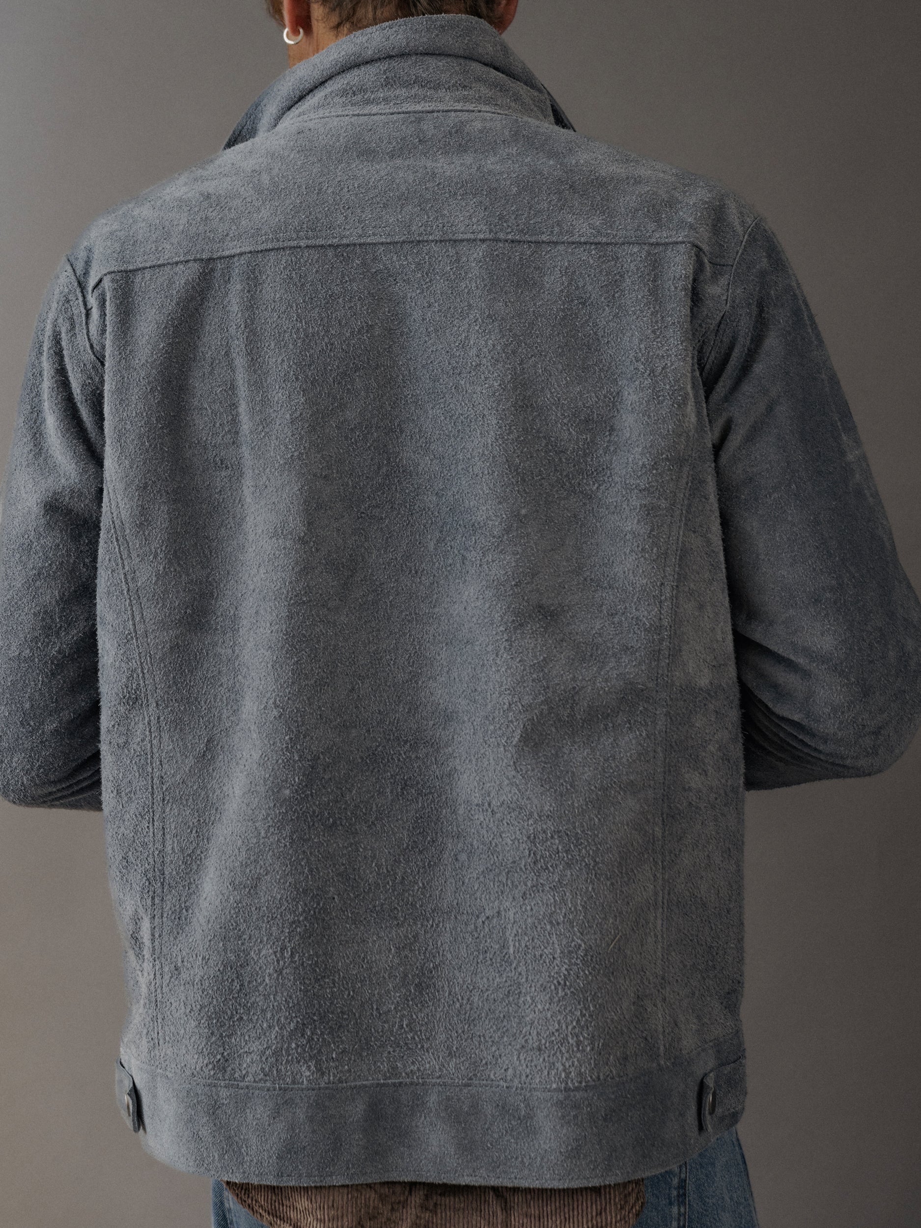 David Dangelo Caldwell grey suede trucker jacket with exposed seams, classic fit, and reversible design.