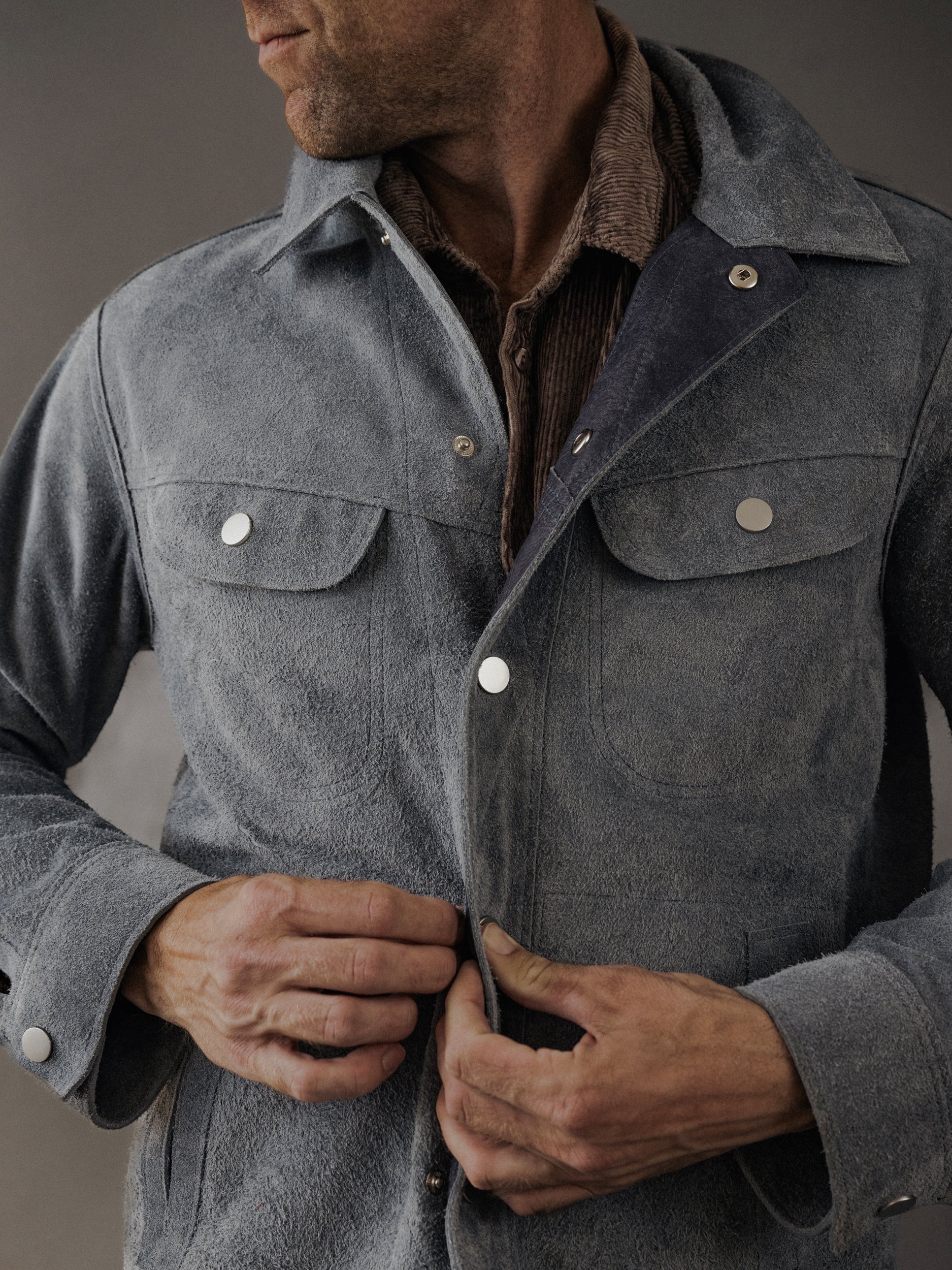 David Dangelo Caldwell grey suede trucker jacket with exposed seams and proprietary hardware, reversible design.