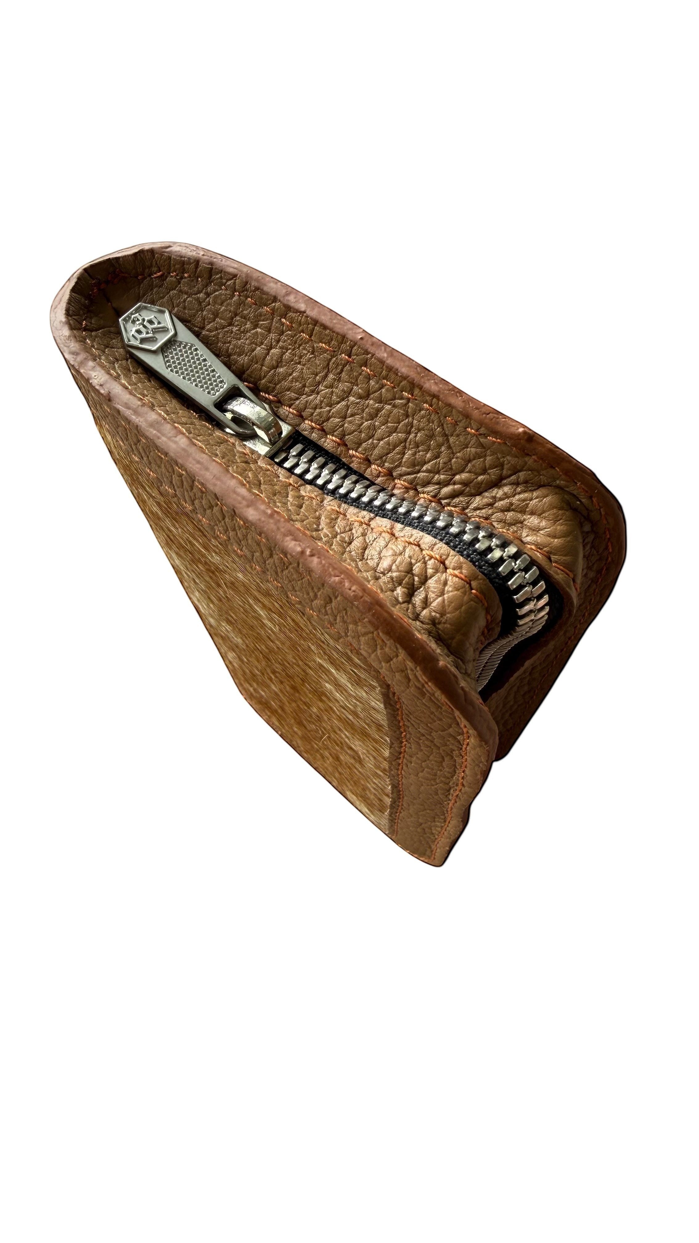 David Dangelo Caldwell tan leather and hair-on hide wristlet clutch with silver zipper detail.