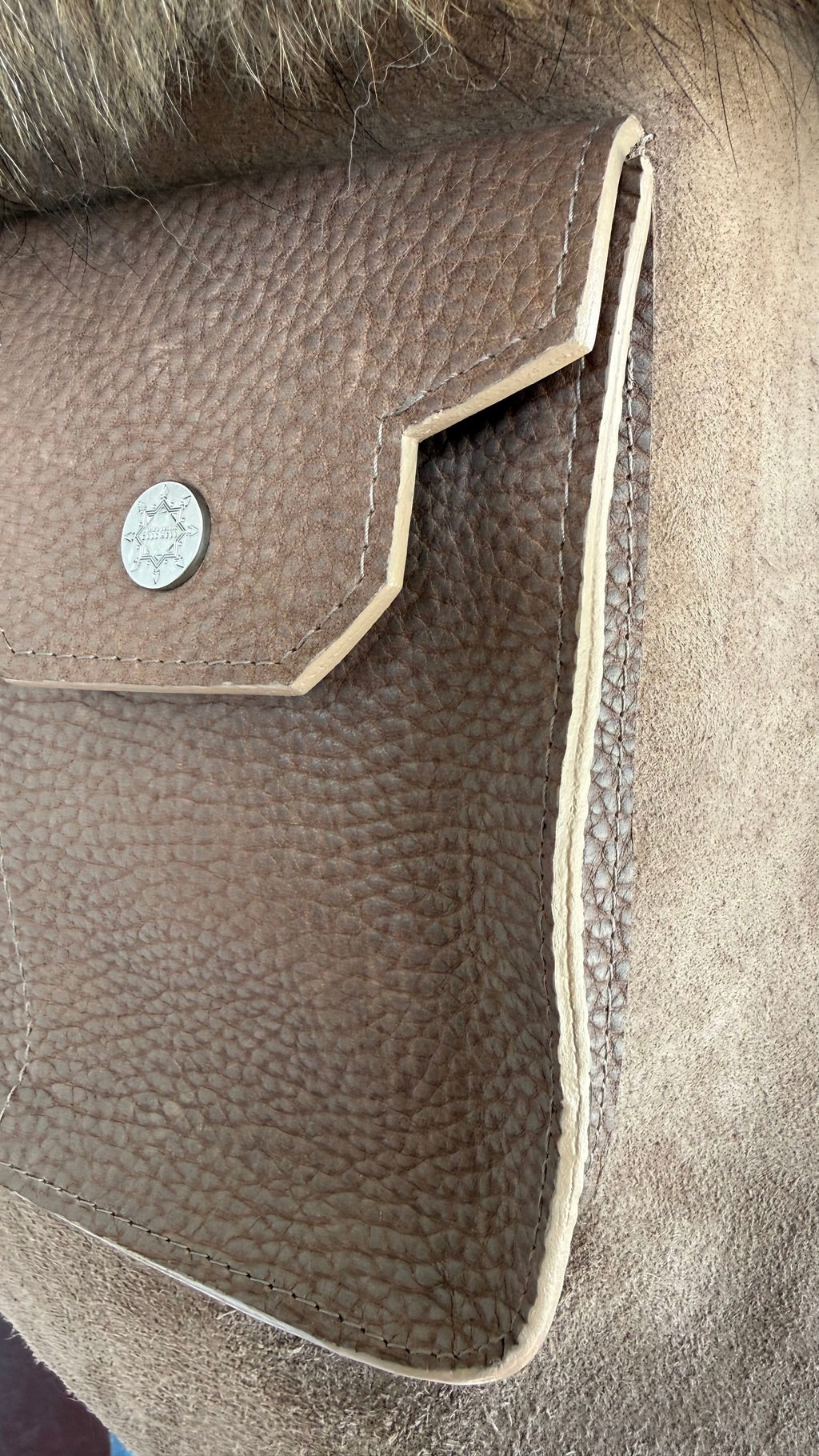 David Dangelo Caldwell brown leather tote with natural Finnish raccoon fur trim and decorative snap closure.