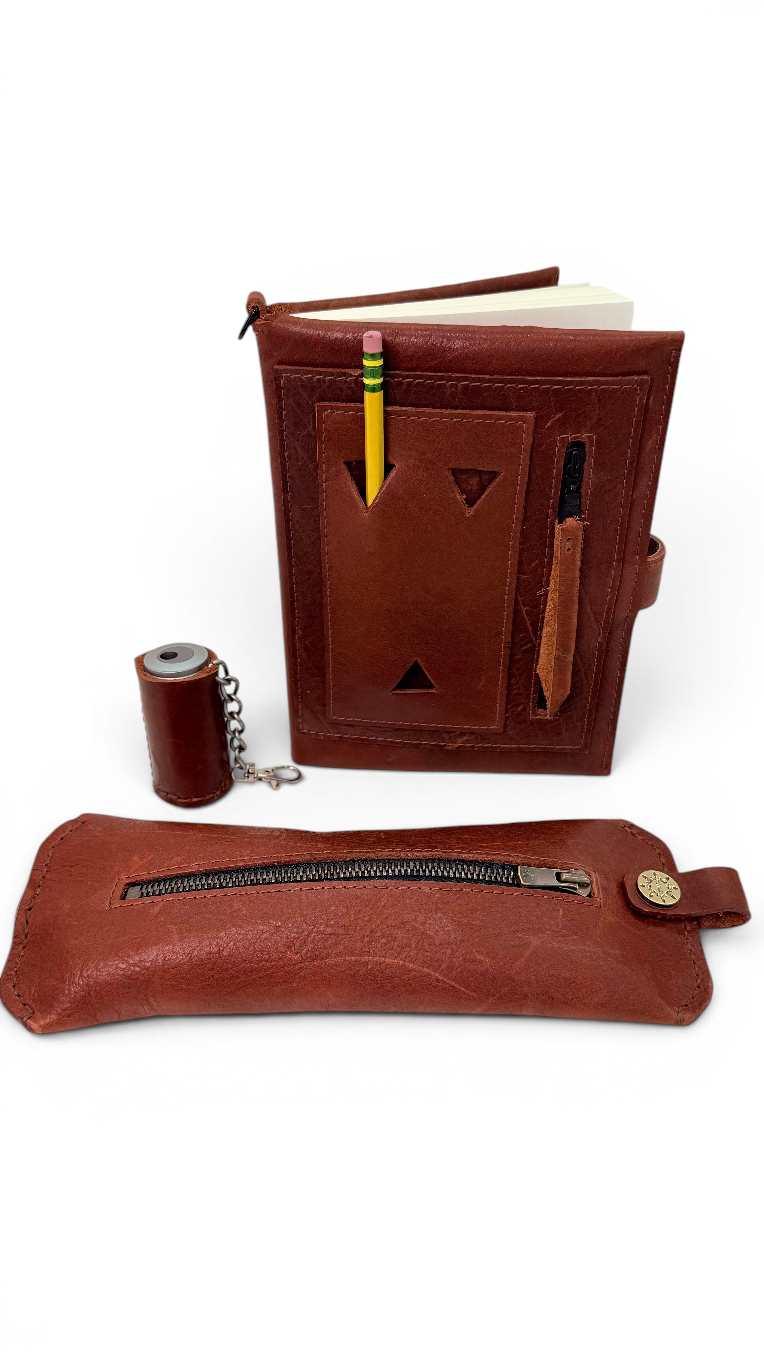 David Dangelo Caldwell brown bison leather pencil pouch with zipper closure and a matching notebook.