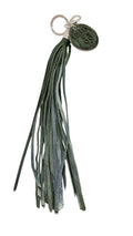 David Dangelo Caldwell hand-cut leather tassel keychain in dark green and grey with a round embossed charm.
