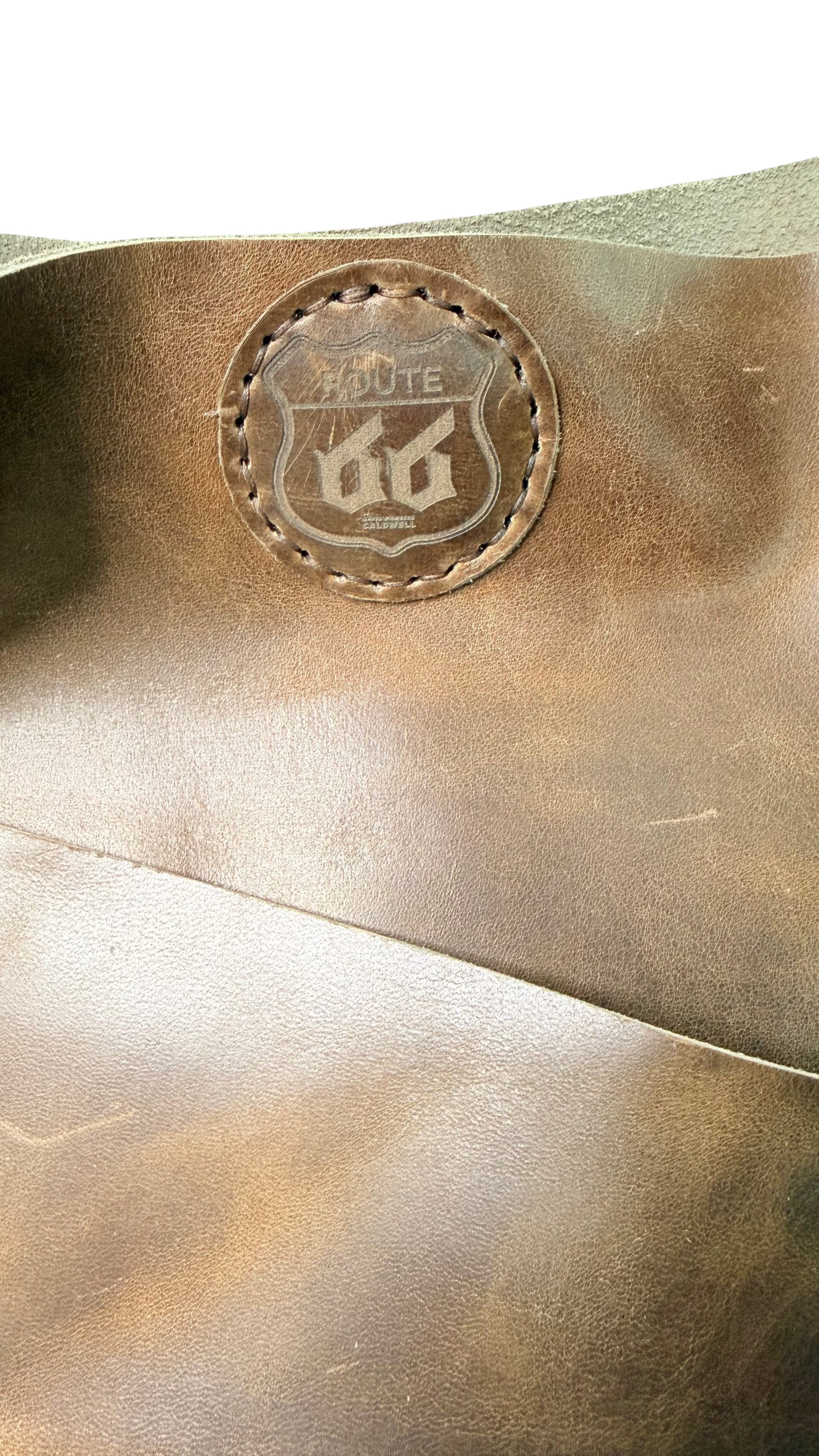 David Dangelo Caldwell brown leather tote bag with fringe detail and Route 66 logo patch.