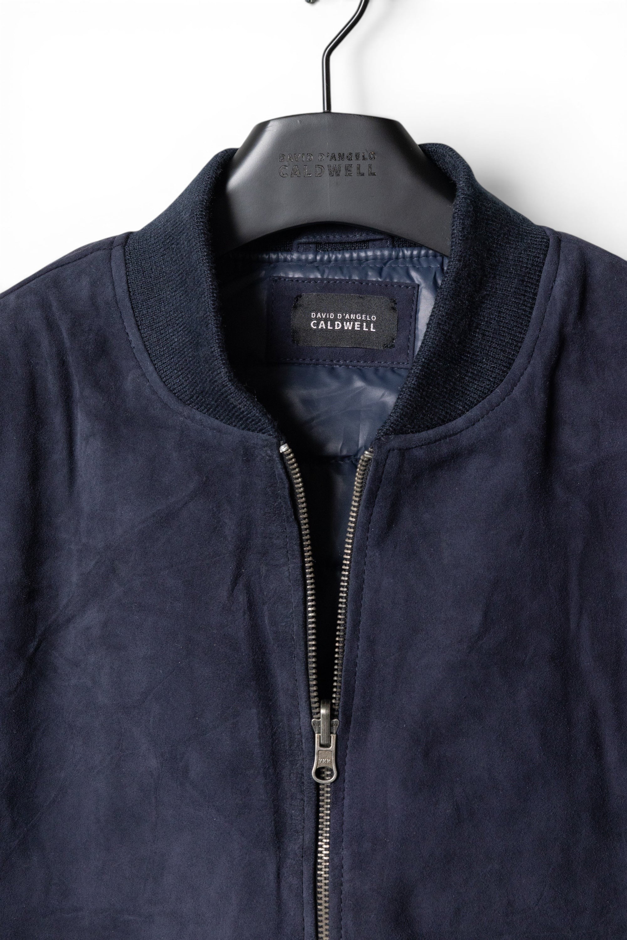David Dangelo Caldwell navy blue suede bomber jacket with puffer lining and silver zipper.