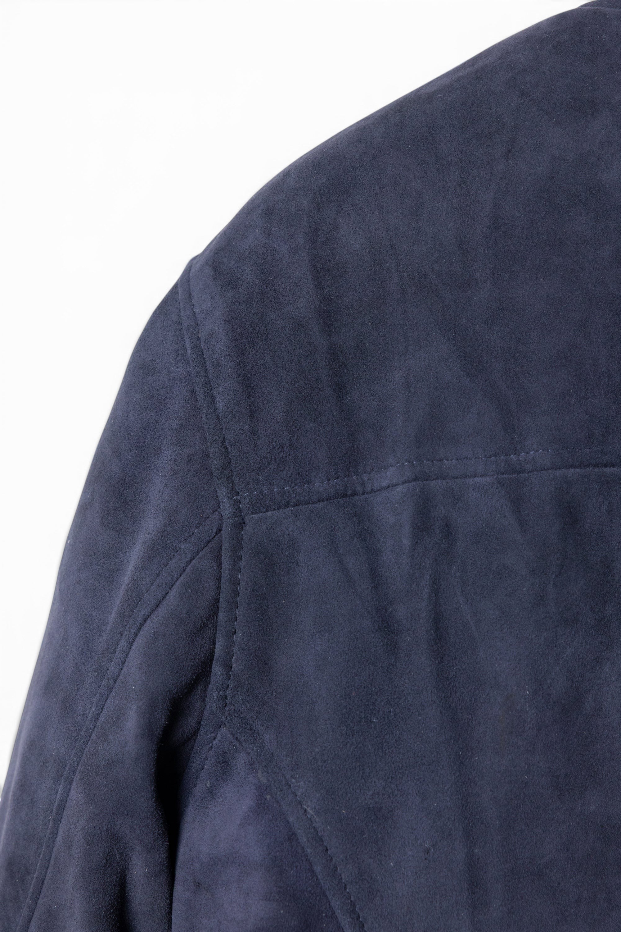 David Dangelo Caldwell navy blue suede bomber jacket with puffer lining. Features classic fit and custom hardware.