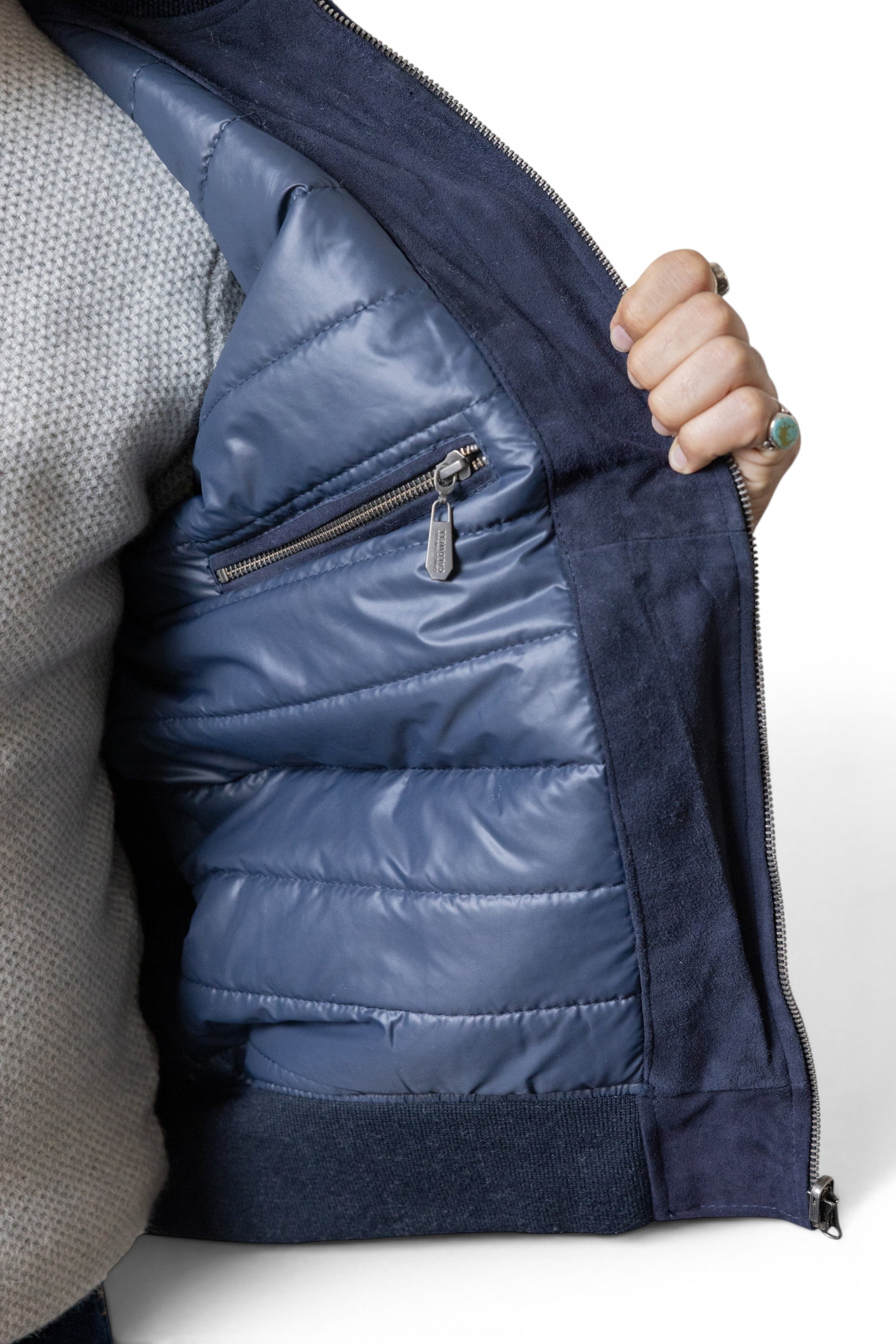 David Dangelo Caldwell navy blue suede bomber jacket with quilted puffer lining and zippered pocket.