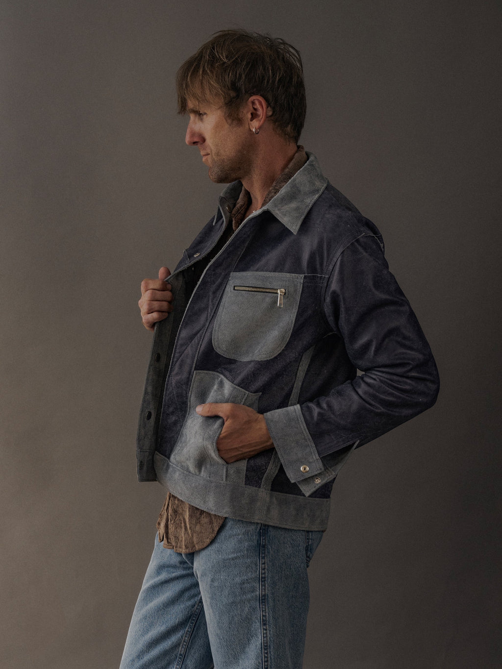 David Dangelo Caldwell reversible trucker jacket in navy suede with grey accents and zippered chest pocket.