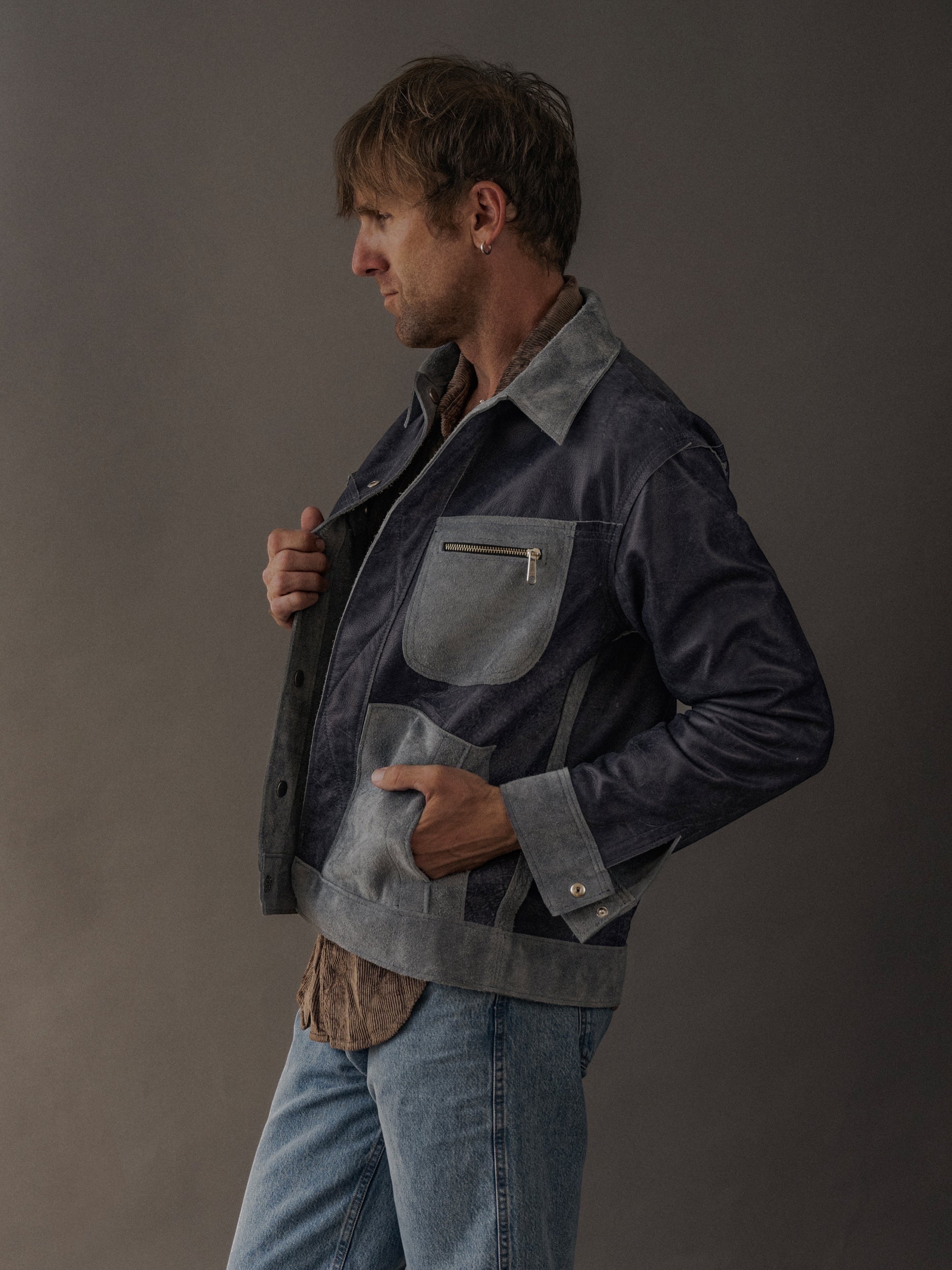 David Dangelo Caldwell reversible trucker jacket in navy suede with grey accents and zippered chest pocket.