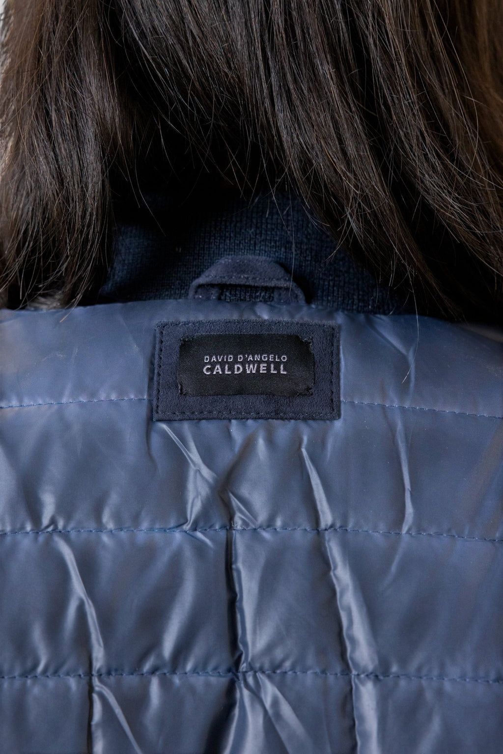 David Dangelo Caldwell navy blue reversible bomber jacket with puffer lining and suede exterior.
