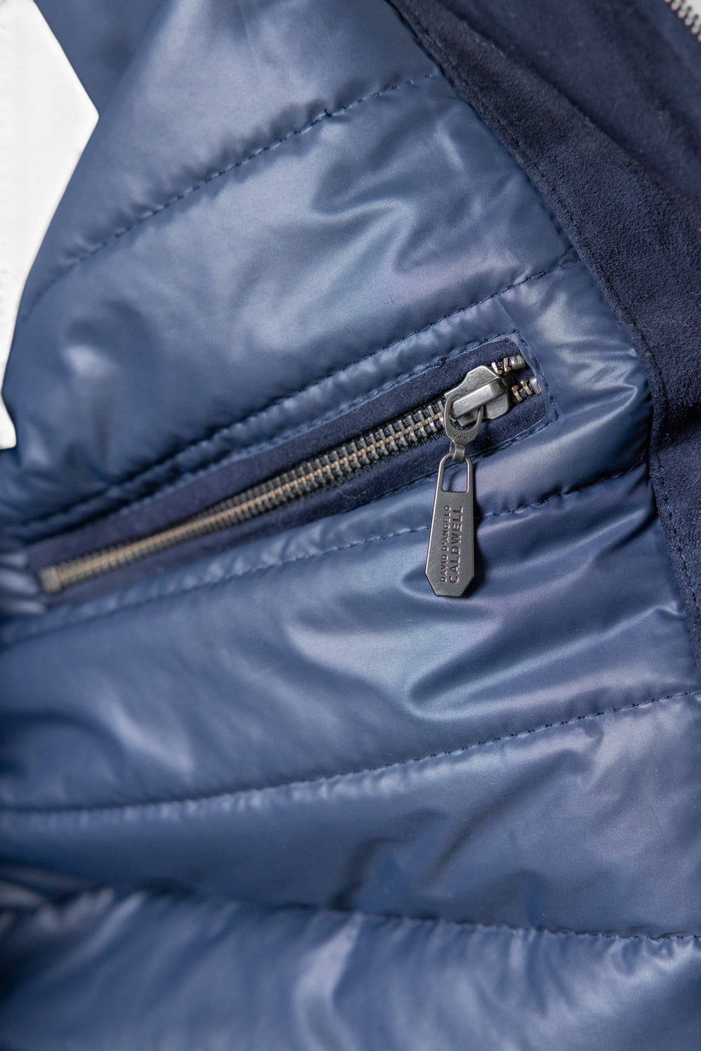 David Dangelo Caldwell navy blue reversible bomber jacket with puffer lining and suede exterior, featuring a zip pocket.