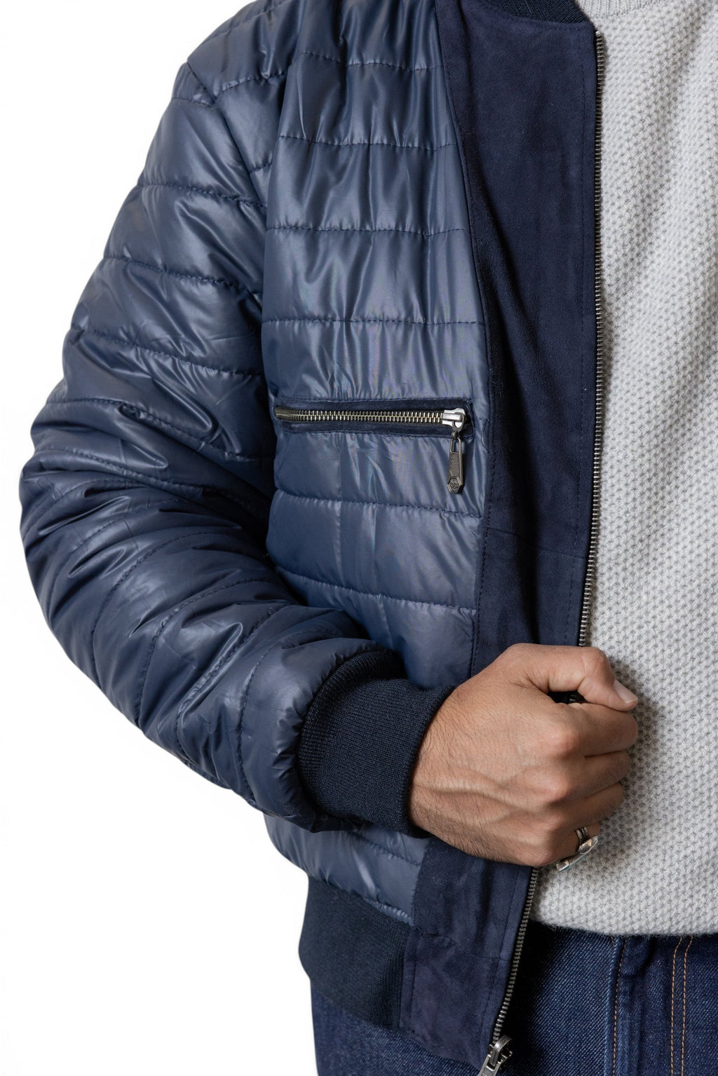 David Dangelo Caldwell navy blue reversible bomber jacket with suede panels and puffer sleeves. Features zip pocket.