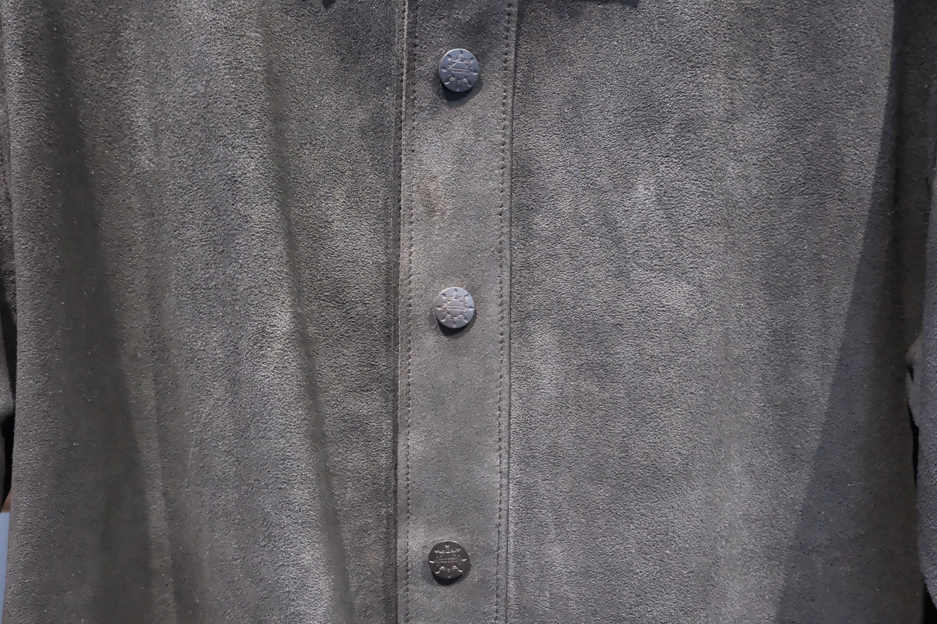 David Dangelo Caldwell dark grey suede jacket with custom hardware buttons and exposed stitching.