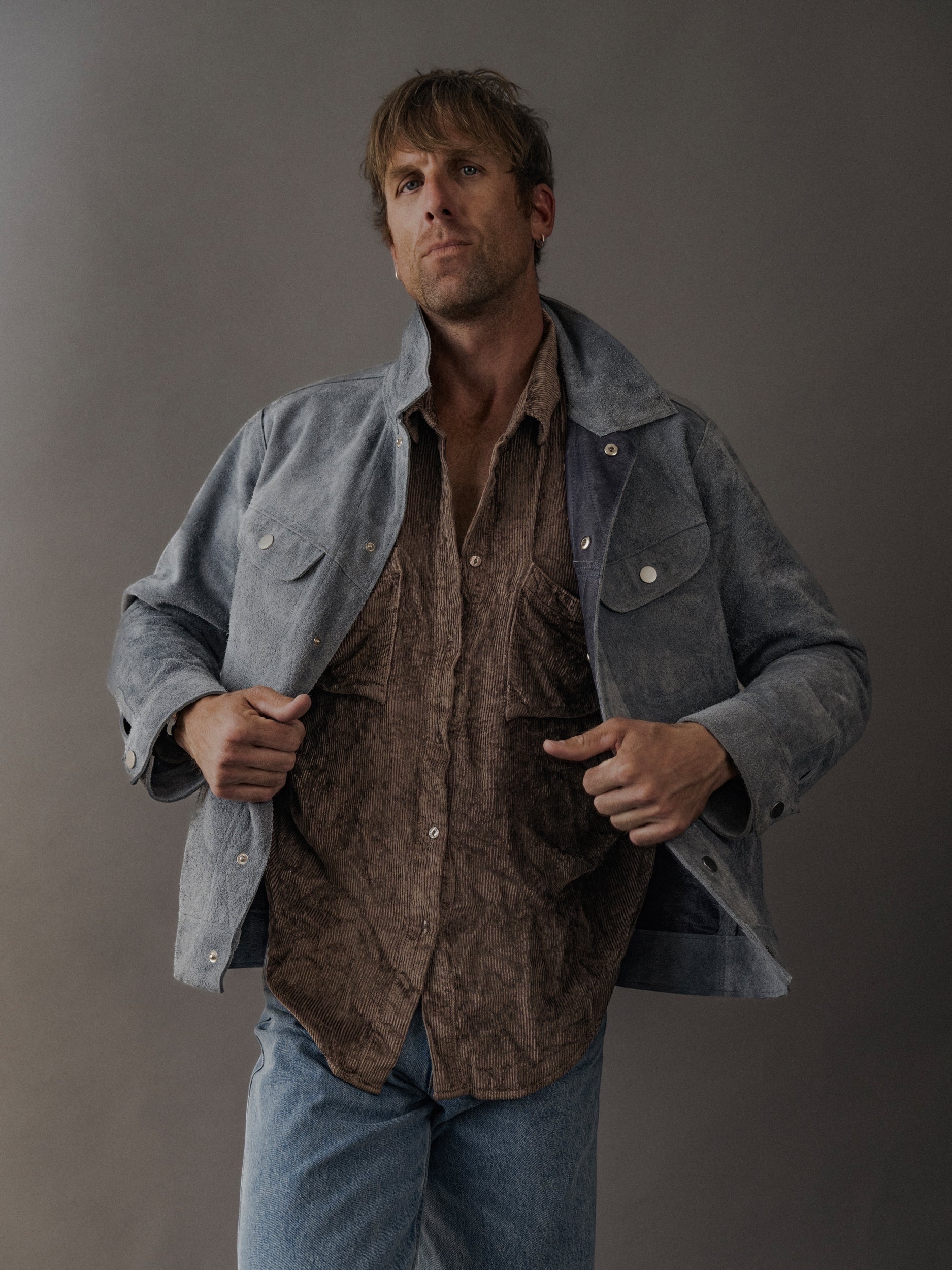 David Dangelo Caldwell light blue suede trucker jacket with exposed seams, reversible design, and proprietary hardware.