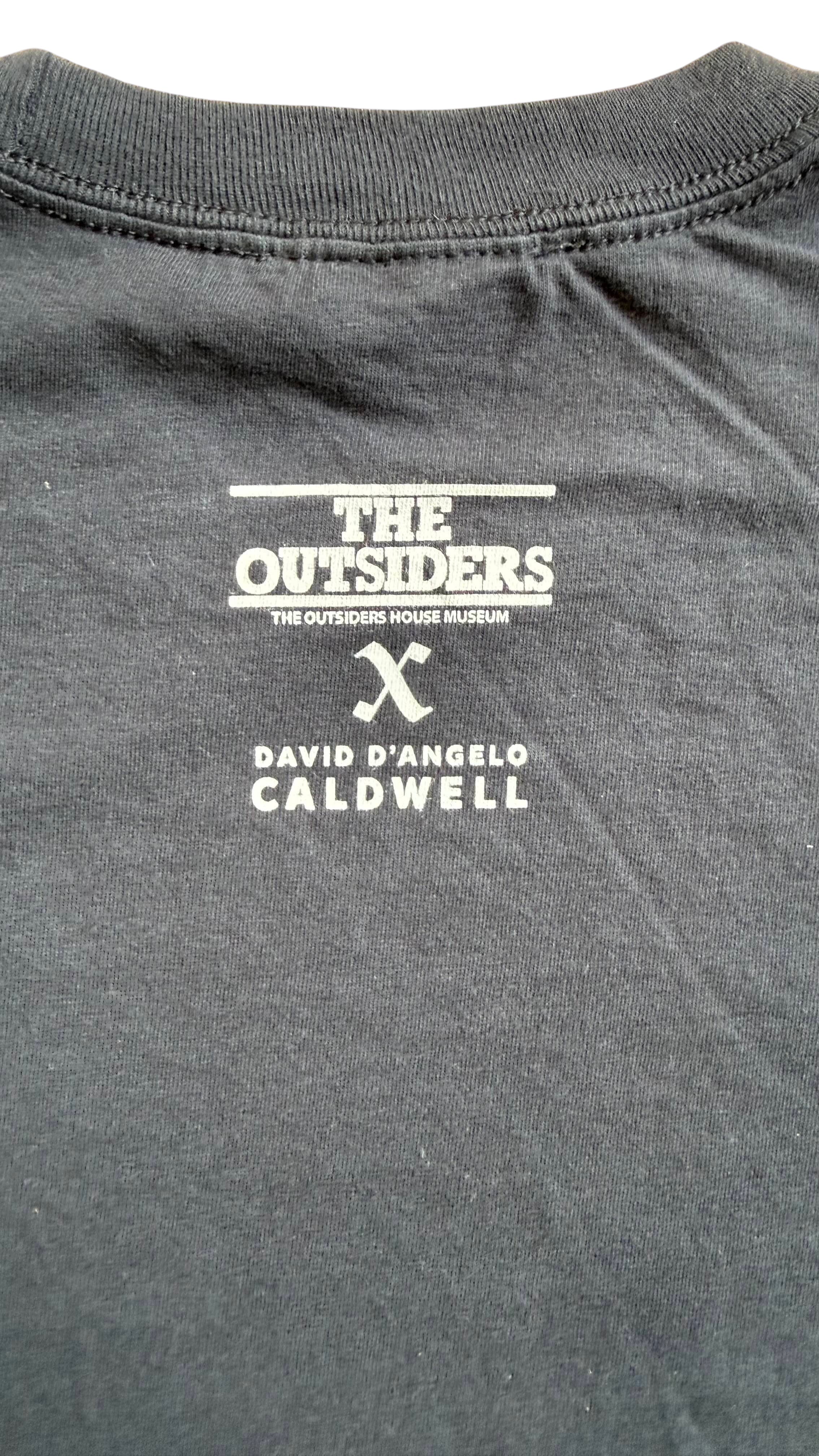 David Dangelo Caldwell black 100% cotton Tulsa Greaser's Club t-shirt with The Outsiders Museum logo.